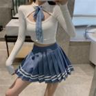Long-sleeve Bow Accent Cutout Crop Top / Striped Mini Pleated Skirt