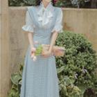 Set: Short-sleeve Tie-neck Frill Trim Blouse + Check Midi A-line Suspender Skirt
