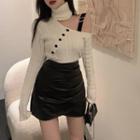 Turtleneck Asymmetrical Cutout Sweater / Faux Leather Skirt