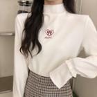Long-sleeve Bow Embroidered Mock-neck Knit Top