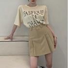 Short-sleeve Round-neck Lettering T-shirt / High-waist A-line Accordion Pleat Mini Skirt